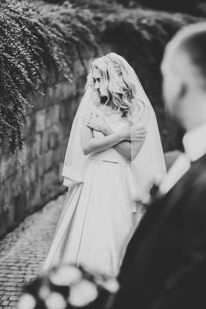 Happy wedding couple walking in a botanical parkの写真素材