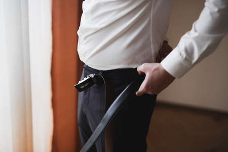 Young handsome man relaxing at his apartment in a hotel after business meetingの写真素材