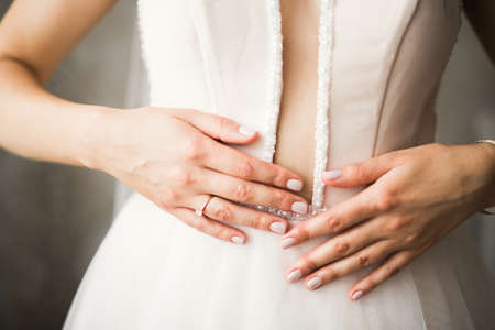 Gorgeous bride in robe posing and preparing for the wedding ceremony face in a roomの写真素材