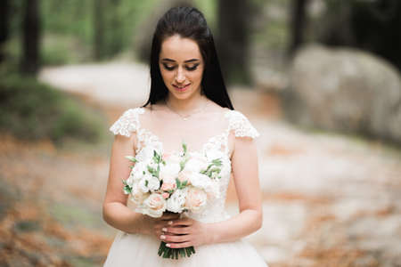 Bride holding big and beautiful wedding bouquet with flowersの写真素材