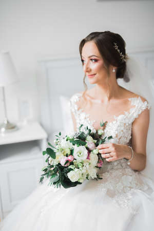 Luxury wedding bride, girl posing and smiling with bouquetの写真素材