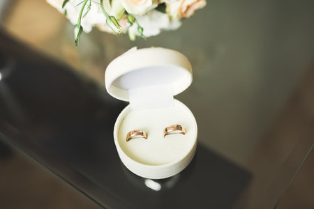 Two golden wedding rings isolated background concept