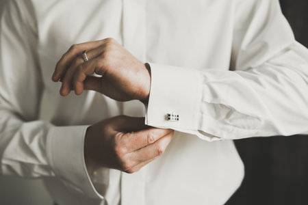 Beautiful man, groom posing and preparing for weddingの写真素材