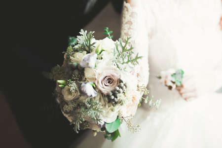 Bride holding big and beautiful wedding bouquet with flowersの写真素材