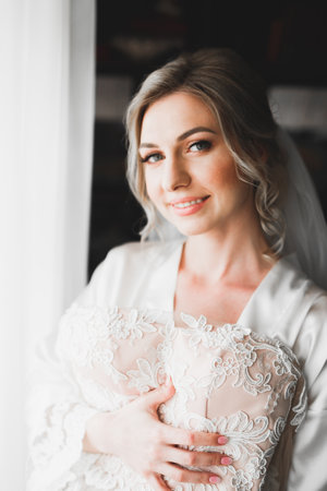Luxury bride in white dress posing while preparing for the wedding ceremonyの写真素材