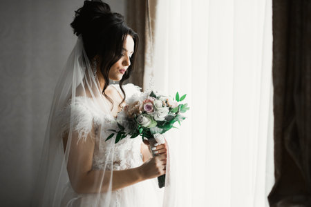 Beautiful fashion bride in wedding dress posingの写真素材