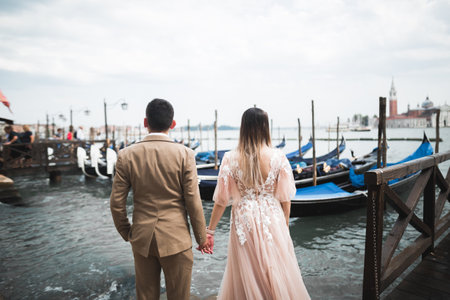 Wedding couple holding hands, groom and bride together on wedding dayの写真素材