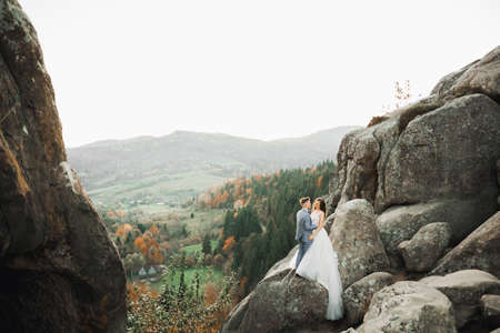 Loving husband and woman on the background of the mountains. Loving couple emotionally spends timeの写真素材