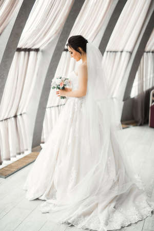 Bride holding big and beautiful wedding bouquet with flowersの写真素材