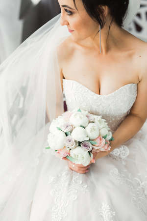 Portrait of stunning bride with long hair posing with great bouquetの写真素材