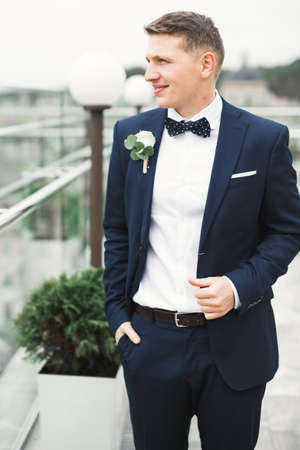 Headshot portrait of young man smiling isolated on outside outdoors backgroundの写真素材