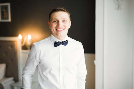 Beautiful man, groom posing and preparing for weddingの写真素材
