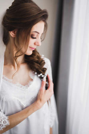 Beautiful bride wearing fashion wedding dress with feathers with luxury delight make-up and...