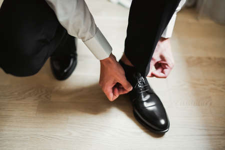 Beautiful man, groom posing and preparing for weddingの写真素材