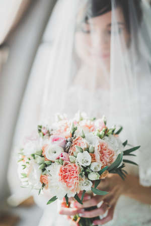 Beautiful fashion bride in wedding dress posingの写真素材