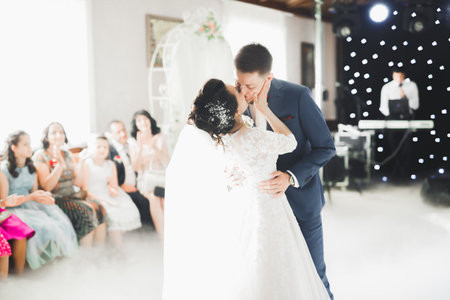 First wedding dance of newlywed couple in restaurant