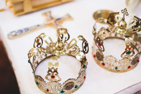 Golden crowns lying on the table in churchの写真素材