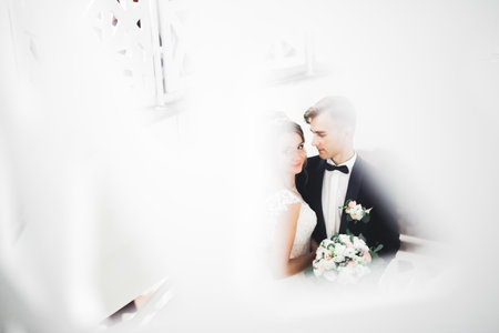Perfect wedding couple holding luxury bouquet of flowersの写真素材