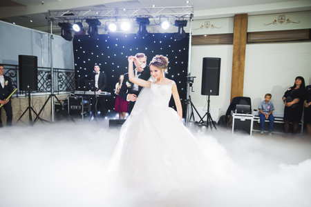 First wedding dance of newlywed couple in restaurantの写真素材