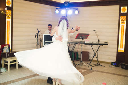 First wedding dance of newlywed couple in restaurantの写真素材