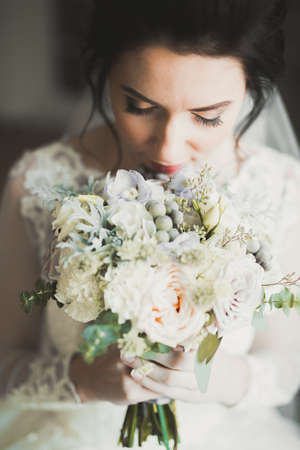 Luxury bride in white dress posing while preparing for the wedding ceremonyの写真素材
