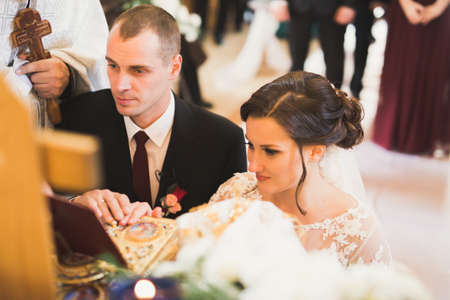 Married couple posing in a church after ceremonyの写真素材