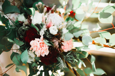 Bride holding big and beautiful wedding bouquet with flowersの写真素材