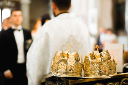 Golden crowns lying on the table in churchの写真素材