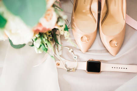 Beautiful toned picture with wedding rings and wedding shoesの写真素材