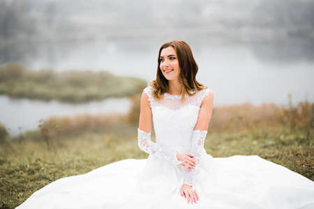 Beauty portrait of bride wearing fashion wedding dress with feathers with luxury delight make-up and hairstyleの写真素材