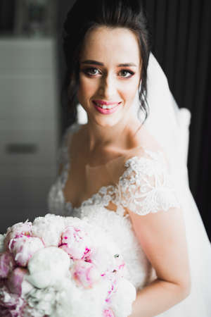 Bride holding big and beautiful wedding bouquet with flowersの写真素材