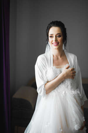 Portrait of beautiful bride with fashion veil at wedding morningの写真素材