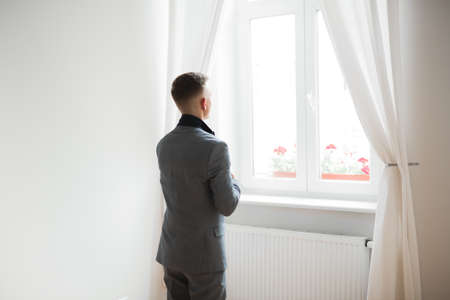 Young handsome man relaxing at his apartment in a hotel after business meetingの写真素材