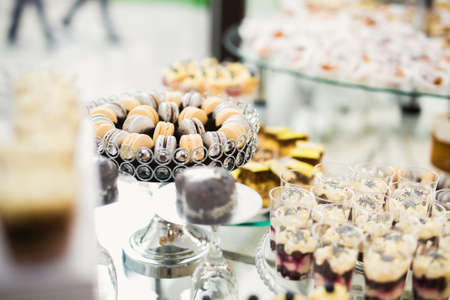 Delicious and tasty dessert table with cupcakes and shots at reception closeupの写真素材