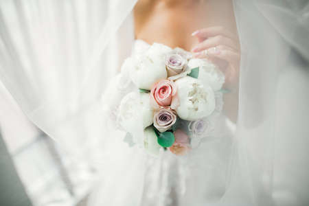 Bride holding big and beautiful wedding bouquet with flowers