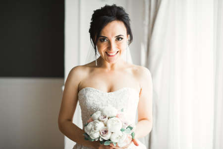 Bride holding big and beautiful wedding bouquet with flowersの写真素材
