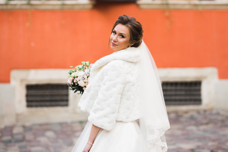 Bride holding big and beautiful wedding bouquet with flowersの写真素材