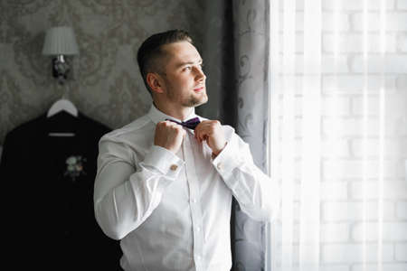 Beautiful man, groom posing and preparing for weddingの写真素材