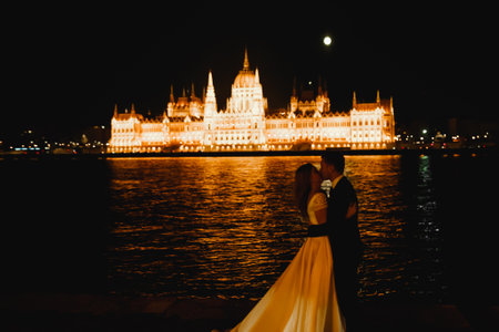 Wedding couple, groom and bride hugging, outdoor near riverの写真素材