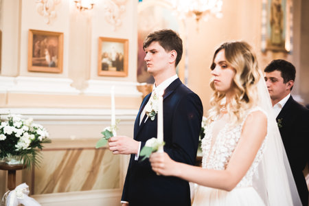 Married couple posing in a church after ceremonyの写真素材