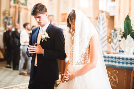 Married couple posing in a church after ceremonyの写真素材