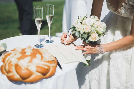 Wedding couple leaving their signatures in the ceremony.の写真素材