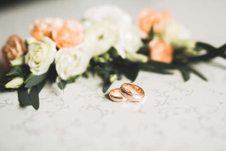 Two golden wedding rings isolated background concept