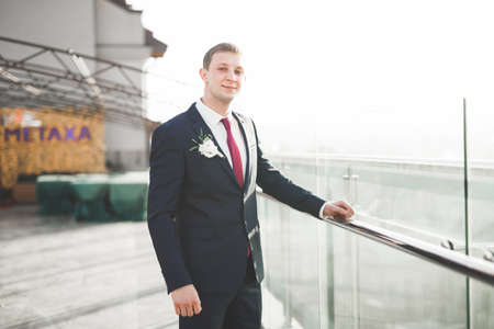 Headshot portrait of young man smiling isolated on outside outdoors backgroundの写真素材