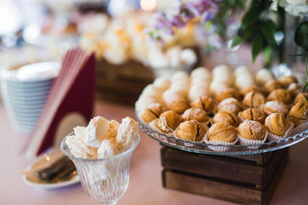 Delicious and tasty dessert table with cupcakes and shots at reception closeupの写真素材