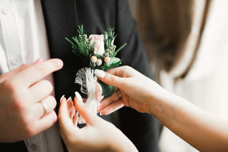 Happy groom posing with boutonniereの写真素材