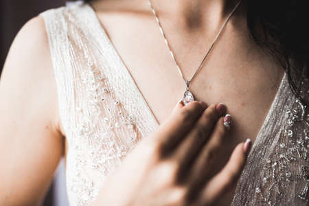 Beautiful bride wearing fashion wedding dress with feathers with luxury delight make-up and hairstyle, studio indoor photo shootの写真素材