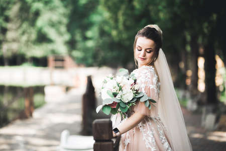 Portrait of stunning bride with long hair posing with great bouquetの写真素材