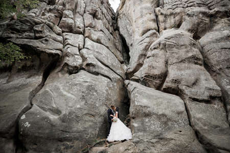 Loving husband and woman on the background of the mountains. Loving couple emotionally spends timeの写真素材