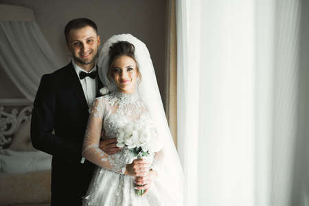 Romantic wedding moment, couple of newlyweds smiling portrait, bride and groom huggingの写真素材